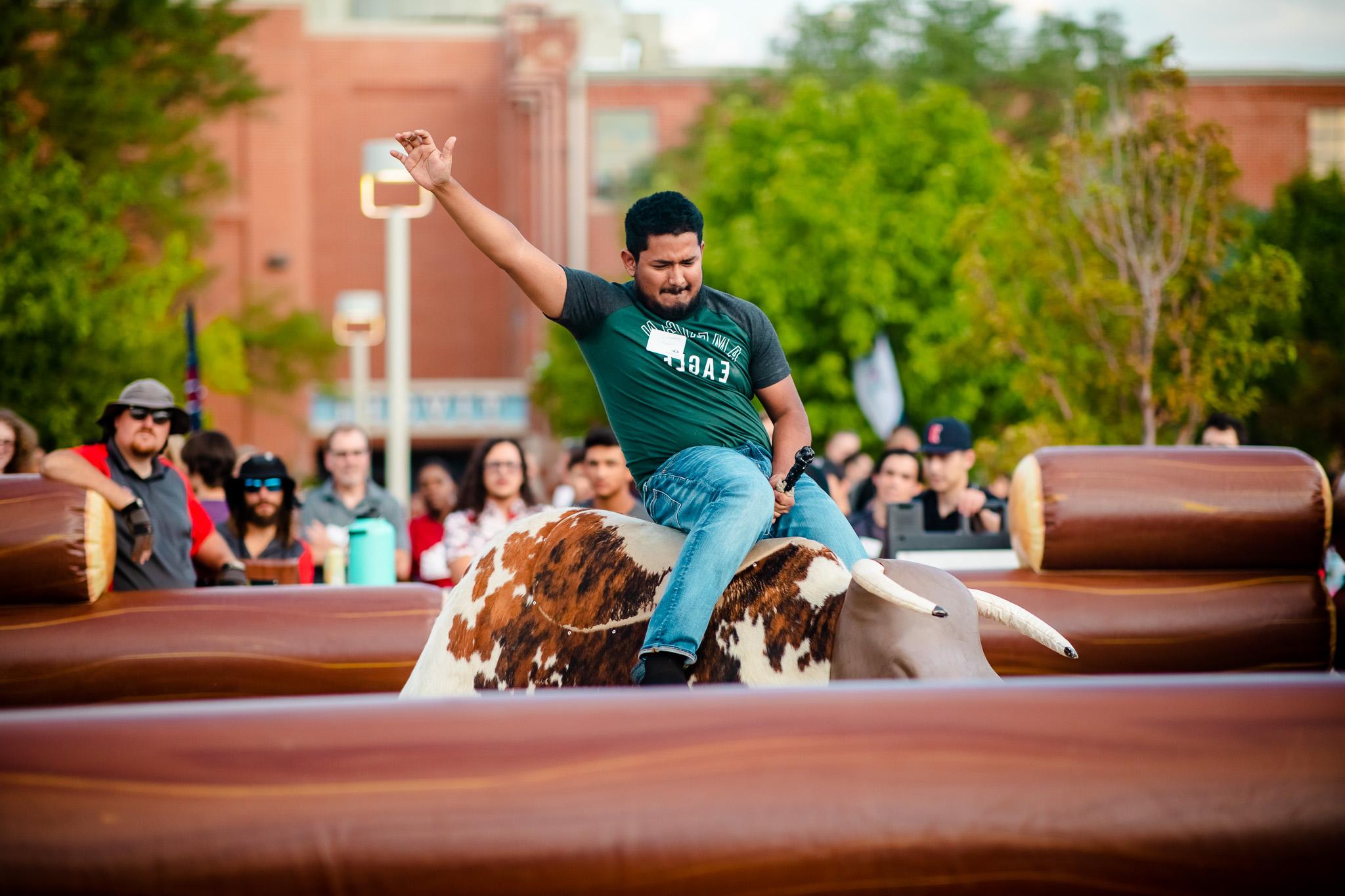 Student on the mechanical bull at convocation