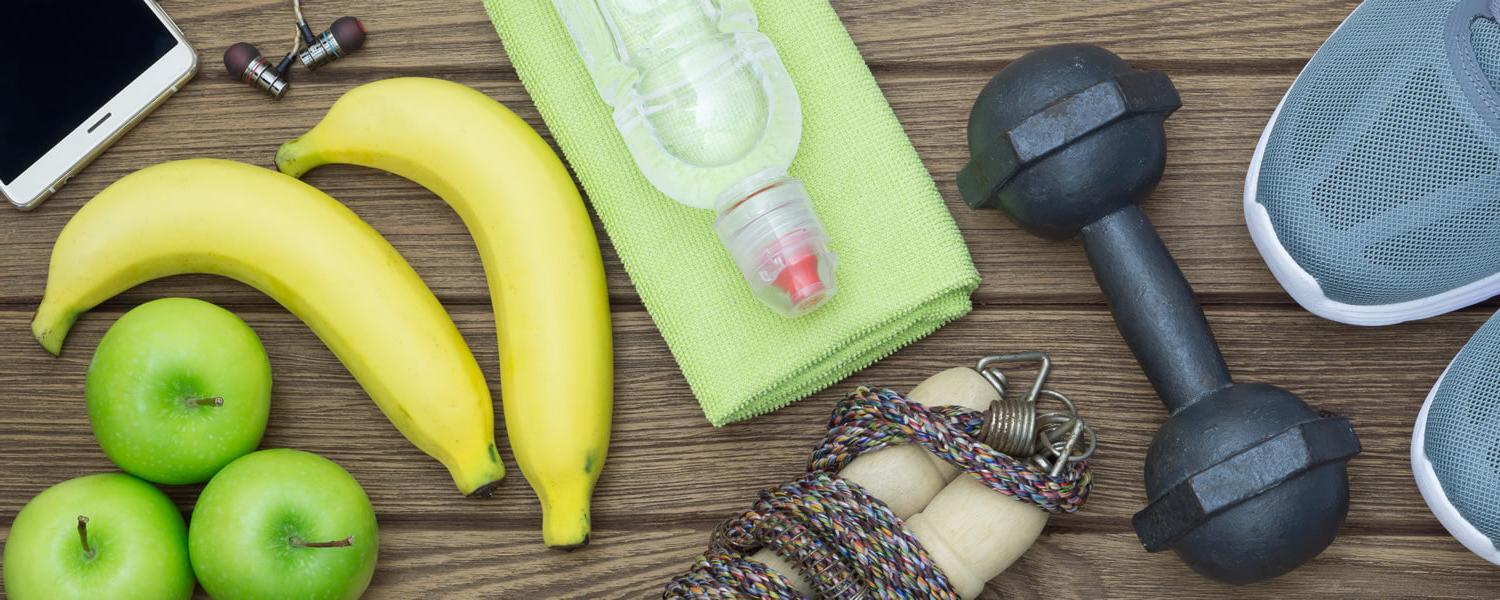 collage of sneakers, dumbbell, water bottle, bananas, apples and a phone