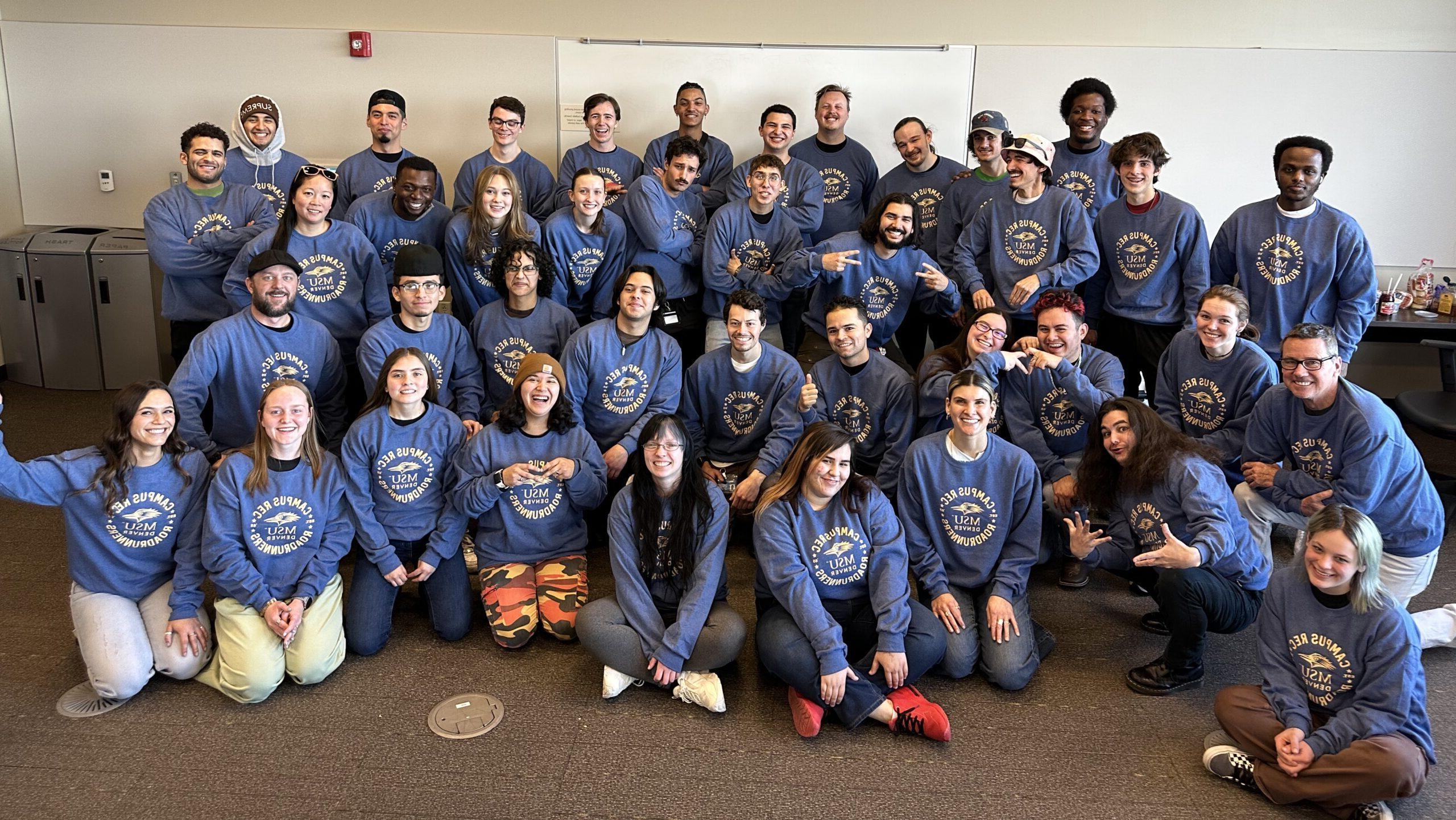 group photo of Campus Recreation staff wearing matching blue sweatshirts