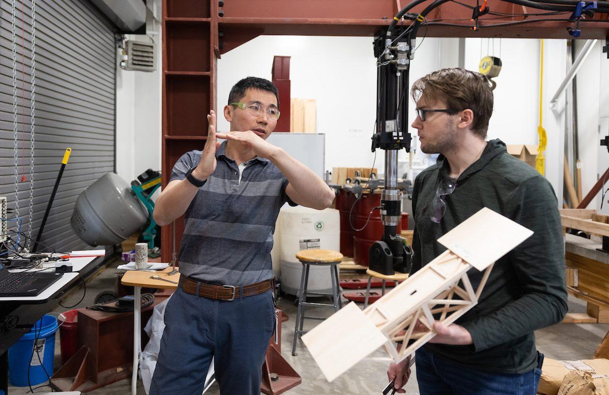 Ryan Walker talks with professor Yishi Lee in Introduction to Mechanical Engineering.