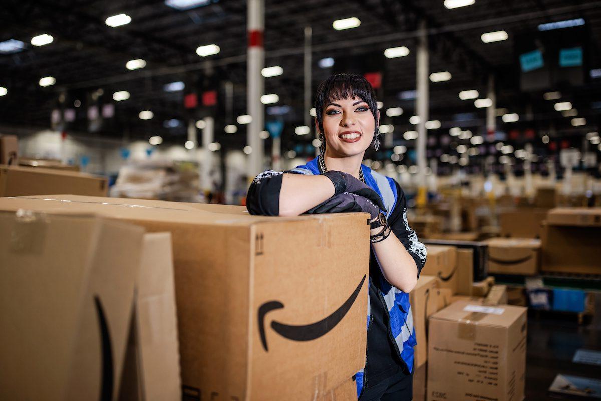 MSU Denver's Shanae Metcalf, an art major and digital media minor, poses in an Amazon warehouse, where she works her day job