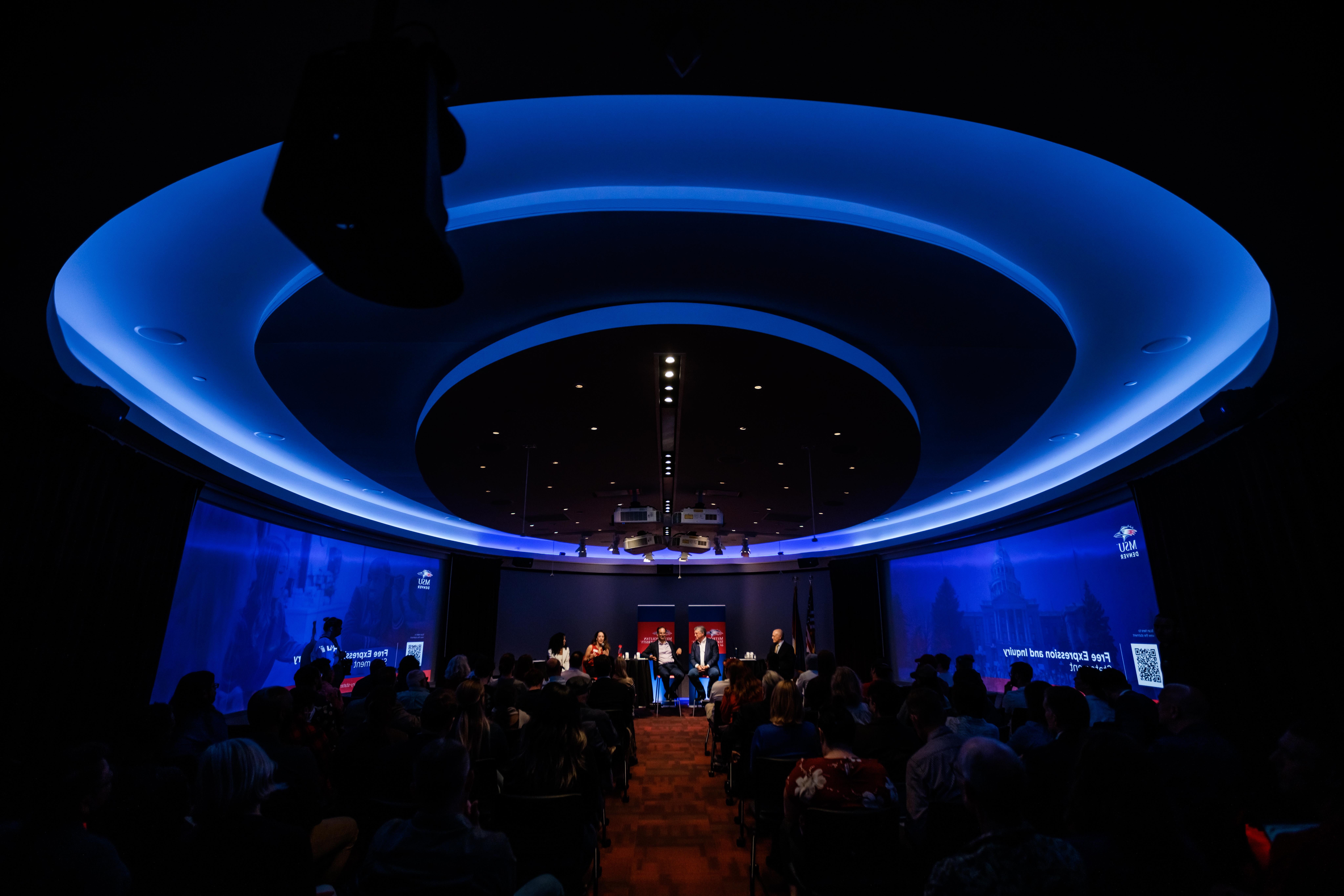 The darkened CAVEA Theater is highlighted by it's custom blue ceiling lighting.